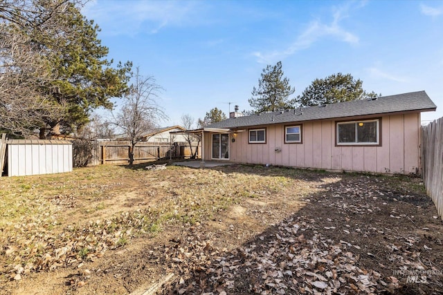 back of house featuring a fenced backyard and a chimney