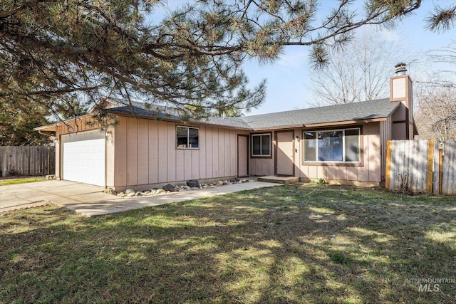 ranch-style house with a front yard, fence, an attached garage, a chimney, and concrete driveway