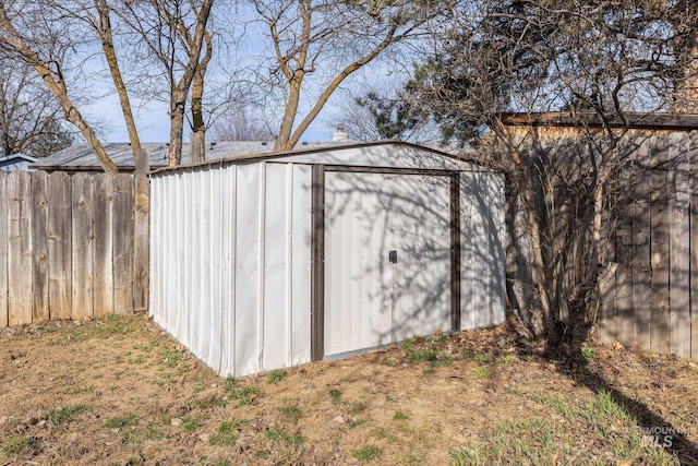 view of shed featuring fence