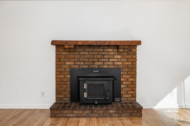 room details with visible vents, baseboards, and wood finished floors