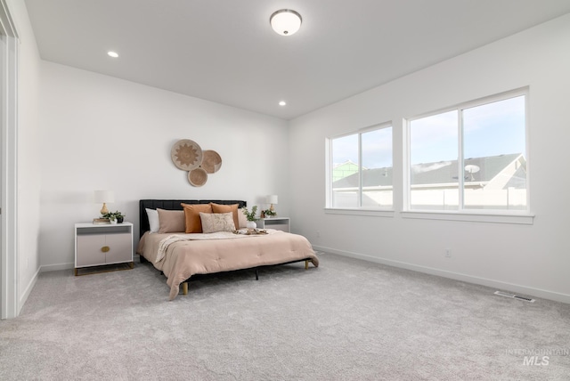 bedroom featuring baseboards, visible vents, and carpet flooring