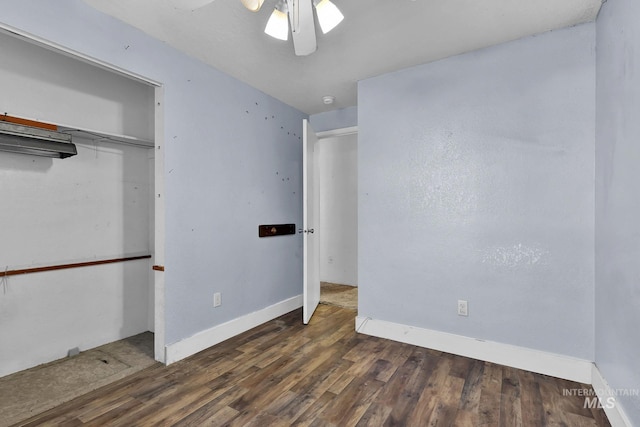 unfurnished bedroom featuring dark hardwood / wood-style floors and ceiling fan