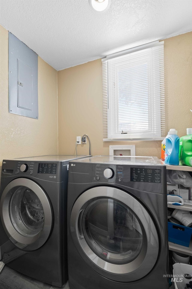 726 Wyoming St, Gooding, ID 83330 - laundry room featuring laundry area, electric panel, a textured ceiling, and separate washer and dryer