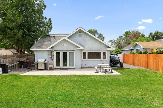 726 Wyoming St, Gooding, ID 83330 - back of property featuring a yard, french doors, a patio area, and stucco siding