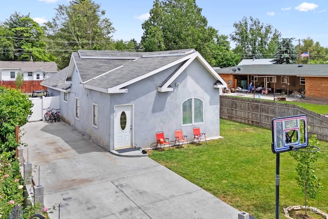 726 Wyoming St, Gooding, ID 83330 - view of front of property with a shingled roof, a front yard, fence, and stucco siding