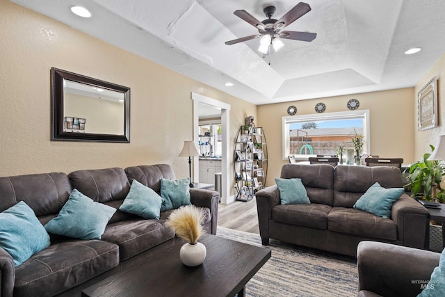 726 Wyoming St, Gooding, ID 83330 - living room featuring recessed lighting, a raised ceiling, a ceiling fan, a textured ceiling, and light wood-type flooring