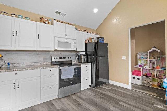 726 Wyoming St, Gooding, ID 83330 - kitchen featuring white microwave, visible vents, light countertops, freestanding refrigerator, and stainless steel range with electric stovetop