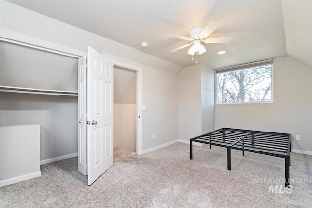 interior space featuring lofted ceiling, a ceiling fan, and carpet floors
