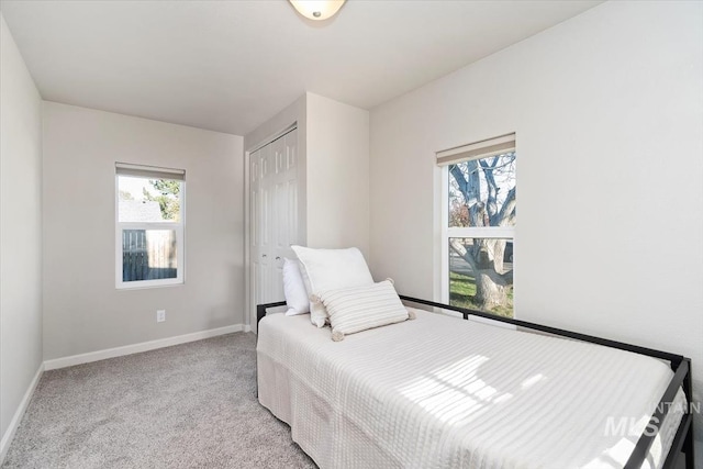 bedroom featuring baseboards, a closet, and carpet