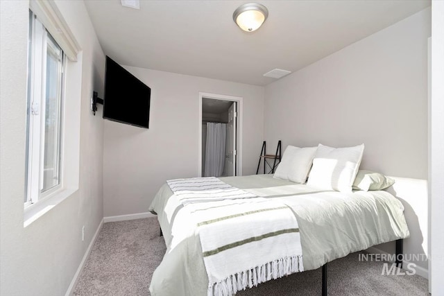 carpeted bedroom with baseboards and visible vents