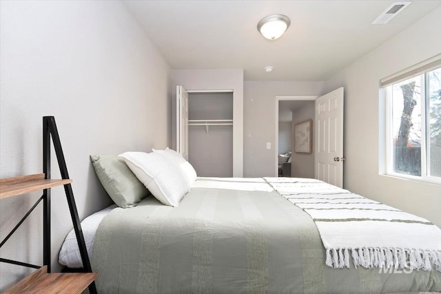bedroom with visible vents and a closet