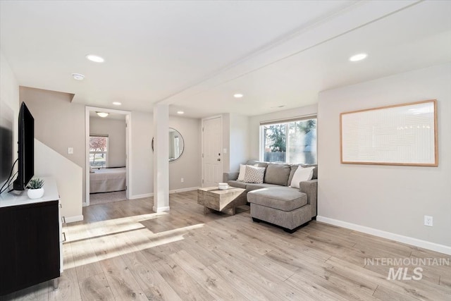 living area with recessed lighting, light wood finished floors, and baseboards
