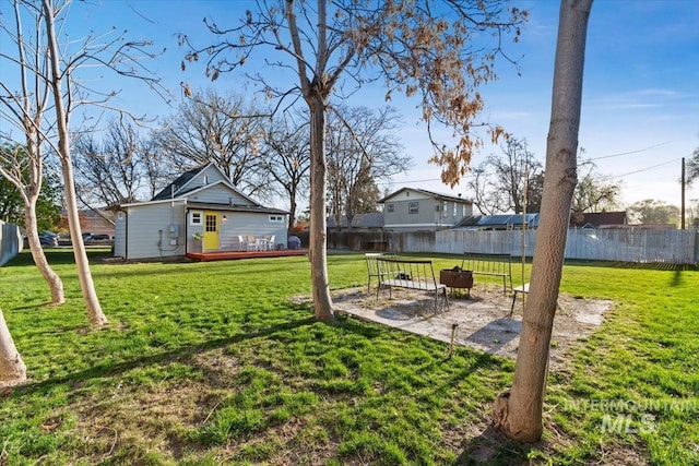view of yard featuring a wooden deck, a patio area, and fence