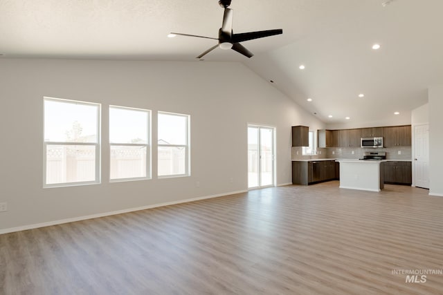 unfurnished living room featuring light hardwood / wood-style floors, high vaulted ceiling, and ceiling fan