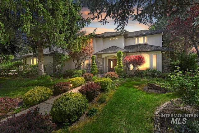 5130 N Lakemont Ln, Garden City, ID 83714 - view of front of house featuring stucco siding, stone siding, and a lawn