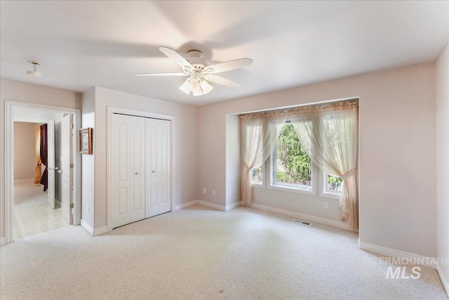 5130 N Lakemont Ln, Garden City, ID 83714 - unfurnished bedroom with light carpet, a closet, baseboards, and ceiling fan