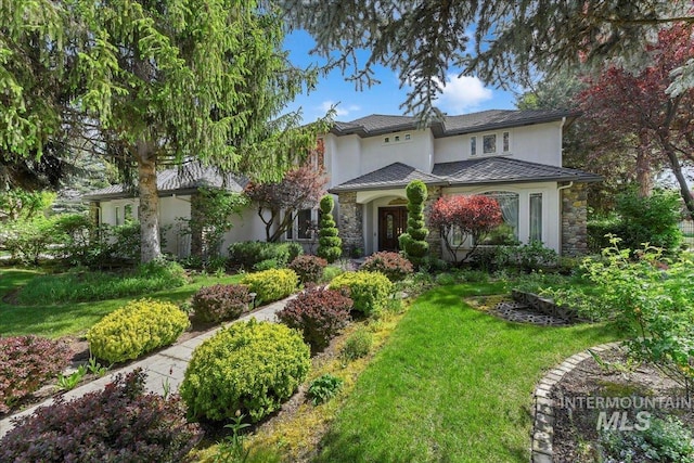 5130 N Lakemont Ln, Garden City, ID 83714 - view of front of house with stucco siding, stone siding, and a front yard