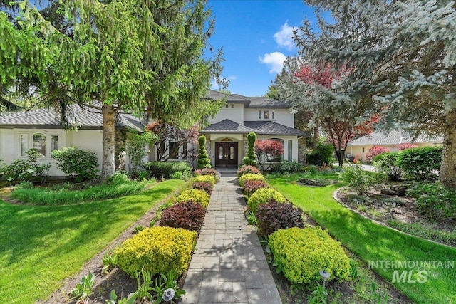 5130 N Lakemont Ln, Garden City, ID 83714 - view of front of home featuring a front lawn, stucco siding, and french doors