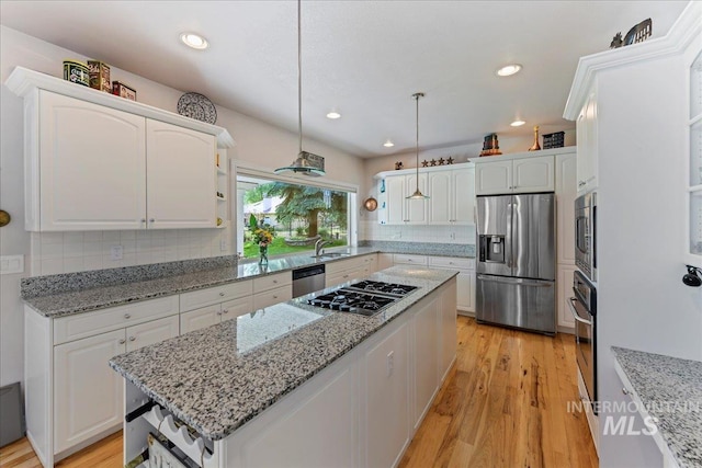 5130 N Lakemont Ln, Garden City, ID 83714 - kitchen featuring appliances with stainless steel finishes, a center island, white cabinets, tasteful backsplash, and recessed lighting