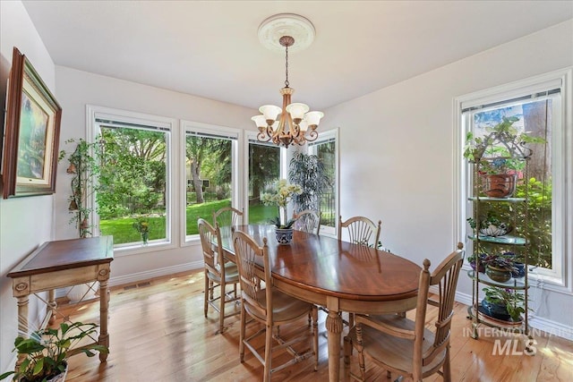 5130 N Lakemont Ln, Garden City, ID 83714 - dining area with a chandelier, light wood-style flooring, and baseboards