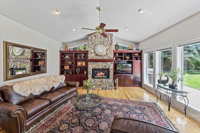 5130 N Lakemont Ln, Garden City, ID 83714 - living room with lofted ceiling, wood finished floors, ceiling fan, and a stone fireplace