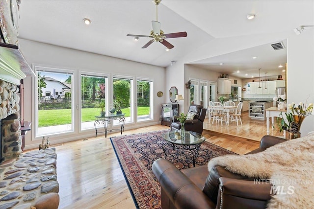 5130 N Lakemont Ln, Garden City, ID 83714 - living room with vaulted ceiling, light wood-type flooring, ceiling fan, recessed lighting, and a fireplace