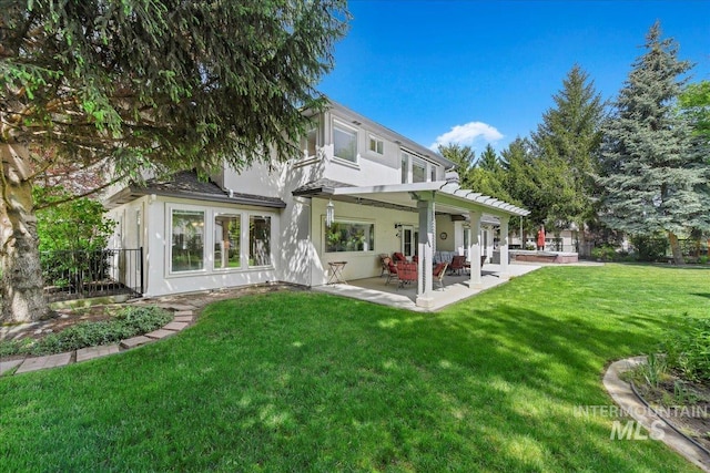 5130 N Lakemont Ln, Garden City, ID 83714 - rear view of house with a patio area, a yard, and stucco siding