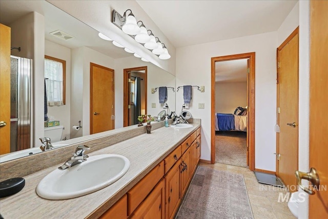 1425 Clements Rd Unit 5, Mccall, ID 83638 - ensuite bathroom with double vanity, a shower stall, tile patterned flooring, toilet, and baseboards