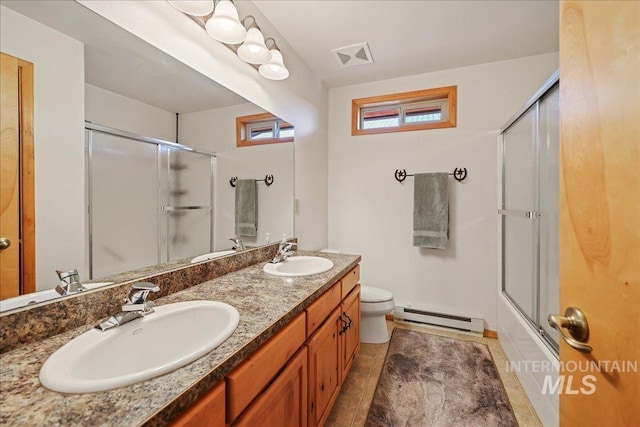 1425 Clements Rd Unit 5, Mccall, ID 83638 - bathroom featuring a baseboard heating unit, double vanity, toilet, tile patterned flooring, and combined bath / shower with glass door