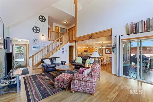 1425 Clements Rd Unit 5, Mccall, ID 83638 - living area with high vaulted ceiling, stairs, wood finished floors, healthy amount of natural light, and a chandelier