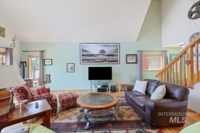 1425 Clements Rd Unit 5, Mccall, ID 83638 - living area featuring wood finished floors, stairs, high vaulted ceiling, and baseboards