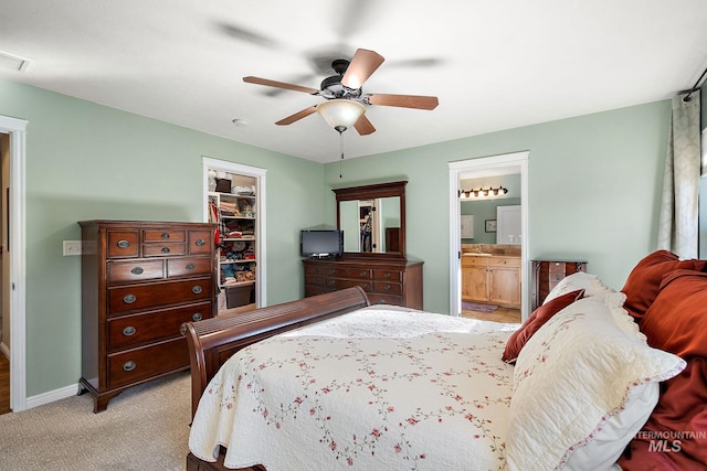 carpeted bedroom featuring ceiling fan, a spacious closet, a closet, and connected bathroom