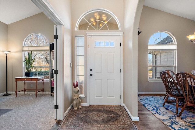 foyer featuring high vaulted ceiling and dark hardwood / wood-style flooring