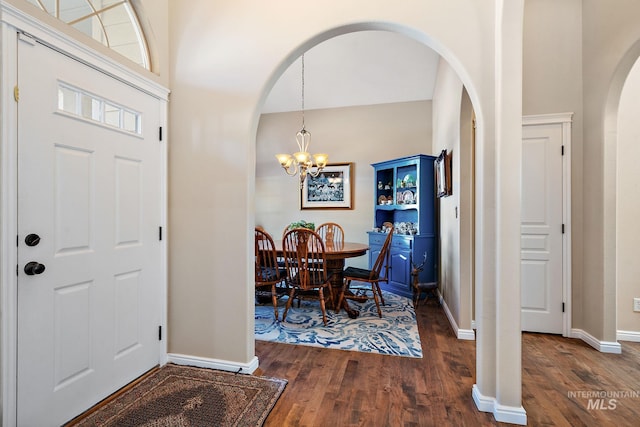 entryway featuring dark hardwood / wood-style flooring and a chandelier