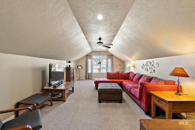 living room featuring lofted ceiling, a textured ceiling, ceiling fan, and light carpet