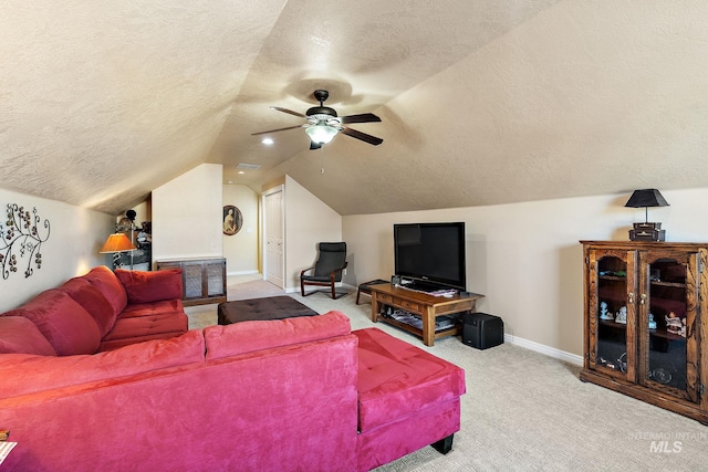 living room featuring a textured ceiling, ceiling fan, vaulted ceiling, and carpet floors