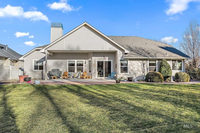 rear view of property featuring a yard and a patio