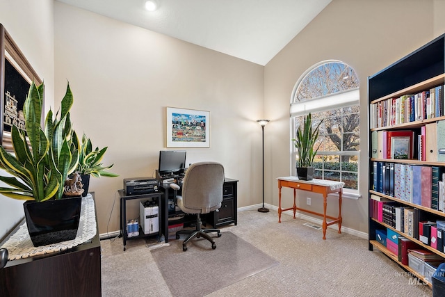 carpeted office with lofted ceiling