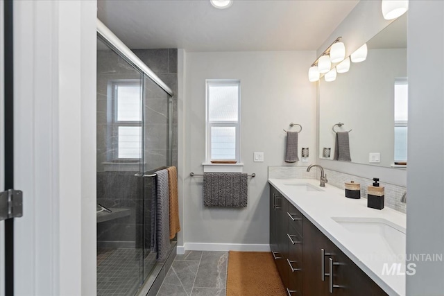 bathroom with vanity and a shower with door