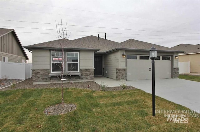 3605 S Edgeview, Nampa, ID 83686 - view of front of home featuring stone siding, an attached garage, concrete driveway, and roof with shingles