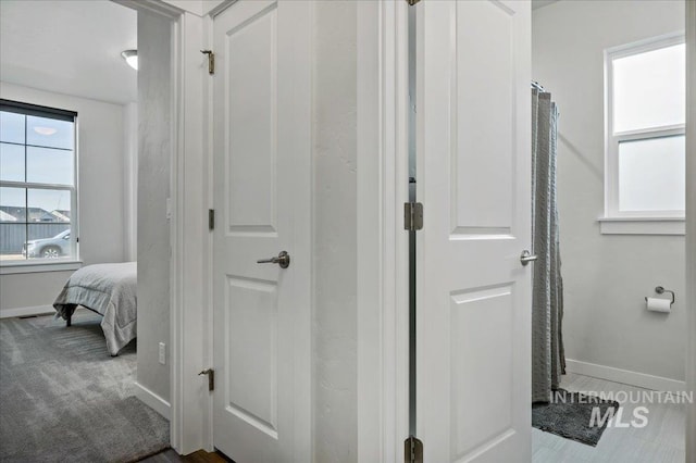 ensuite bathroom with baseboards and ensuite bathroom