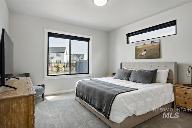 bedroom with baseboards and carpet