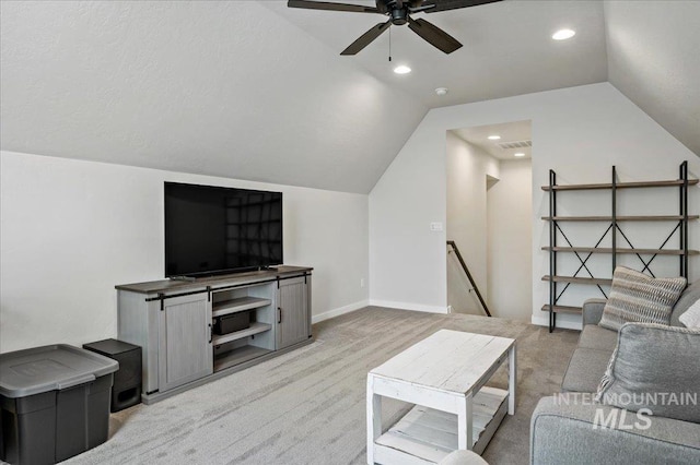 living area featuring a ceiling fan, baseboards, lofted ceiling, recessed lighting, and light carpet