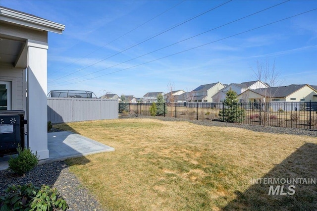 view of yard with a fenced backyard and a residential view