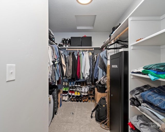 spacious closet with carpet floors and attic access