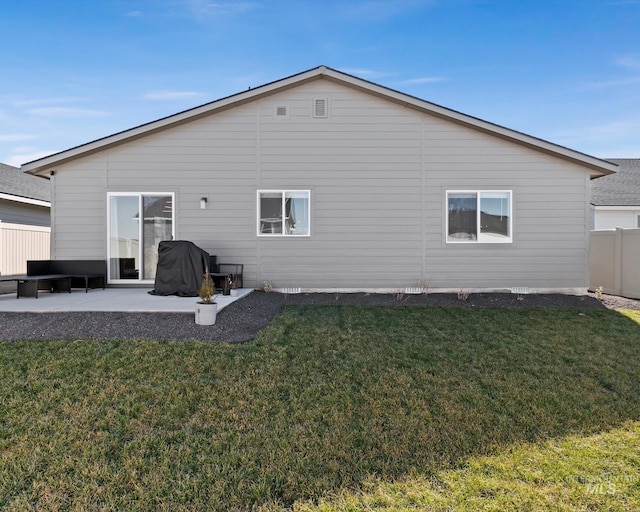 back of house featuring a yard, a patio, and fence