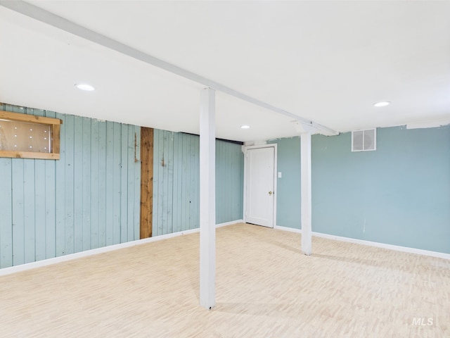 finished basement with wooden walls, recessed lighting, baseboards, wood finished floors, and visible vents