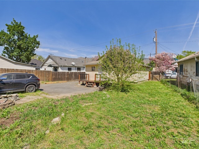 view of yard featuring a fenced backyard, a patio area, and a wooden deck