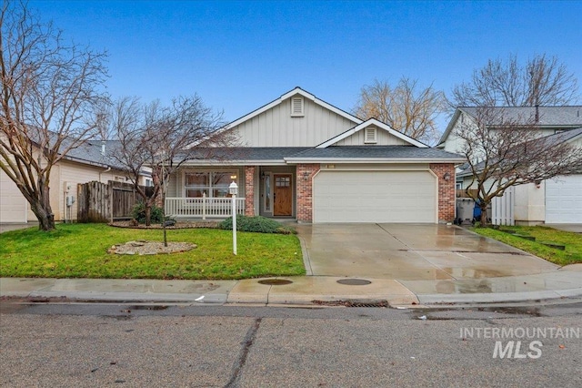 view of front of property featuring a front yard, a porch, and a garage