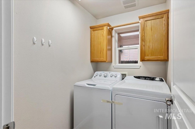 laundry area with cabinets and washer and dryer